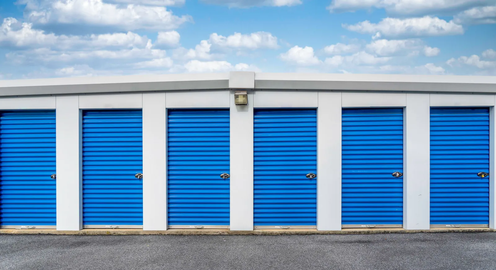 Fenced storage facility with blue roll up doors